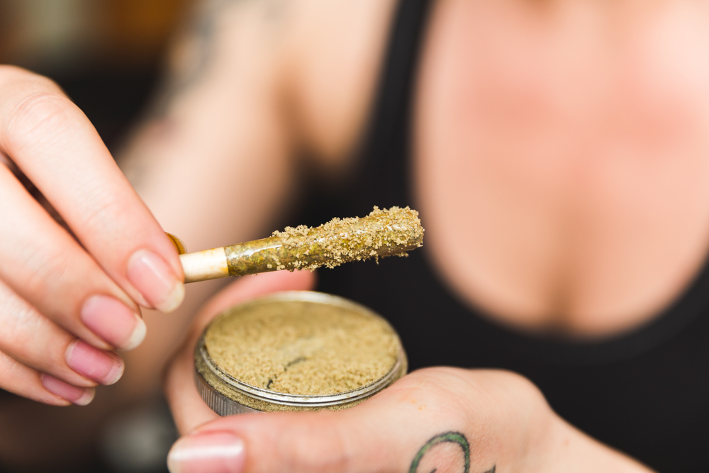 woman holding marijuana joint in hand